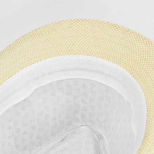 Detail of the internal sweatband and breathable mesh lining of a straw fedora hat