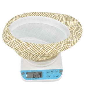 Detailed view of a lightweight 61.4g checkered straw fedora hat on a digital scale