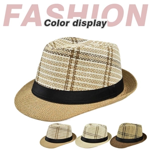 Detailed close-up of straw fedora hats in beige and brown with striped checkered patterns