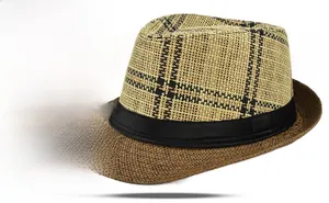 Detail of two-tone woven fedora straw hat with plaid crown and black ribbon band
