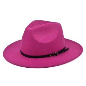 Close-up of rose red wool fedora hat with black faux leather band and gold buckle detail