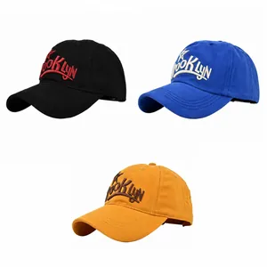 Detailed view of Brooklyn 3D embroidery on black, blue, and yellow baseball caps