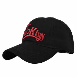 Detail view of red 3D Brooklyn embroidery on a premium black cotton baseball cap