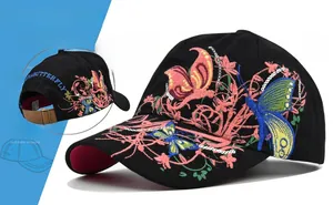 Close-up of butterfly floral embroidery and white sequins on a black baseball cap detail