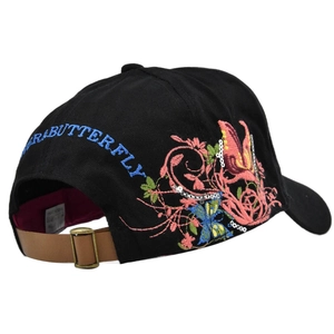 Close-up of butterfly embroidery and brown leather strap on a black baseball cap