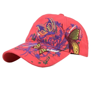 Detailed view of heavy butterfly embroidery with sequins on a red baseball cap