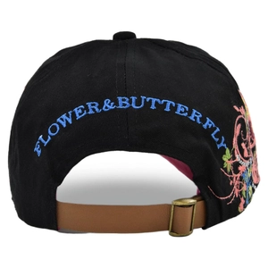 Black canvas baseball cap featuring blue floral embroidery and brown leather strap back