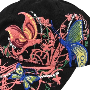 Close-up of vibrant 3D butterfly embroidery and silver sequins on black baseball cap