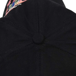 Macro detail of high-quality cotton twill black baseball cap with floral embroidery