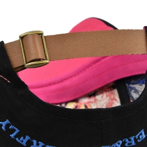 Close-up of baseball cap back showing leather strap, bronze buckle, and FLY ERA embroidery