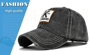 Detail of distressed dark grey baseball cap with K & K China patch and white stitching