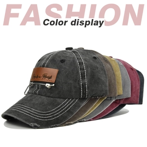 Detail of vintage washed cotton baseball caps showing diverse colors and metal zipper patch