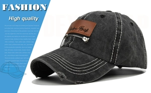 Close-up of distressed baseball cap with zipper detail and leather patch on vintage denim