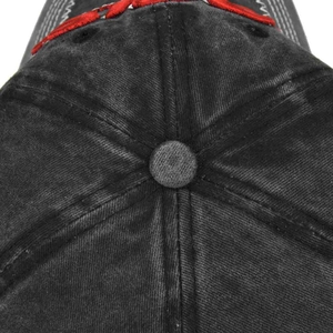 Detailed top view of a washed black cotton baseball cap showing button and stitching details