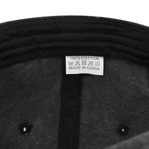 Detail view of cotton baseball cap interior showing 100% cotton washing label and stitching