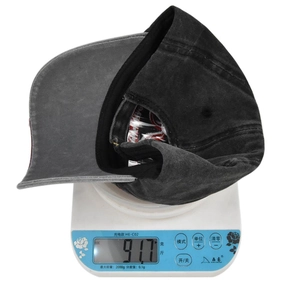 Detail showing the lightweight distressed baseball cap weighing 91.7g on an electronic scale