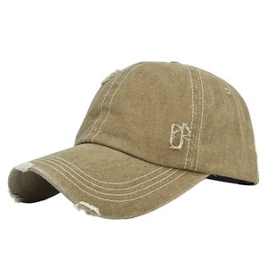 Detail view of khaki distressed baseball cap with white contrast stitching and torn edges