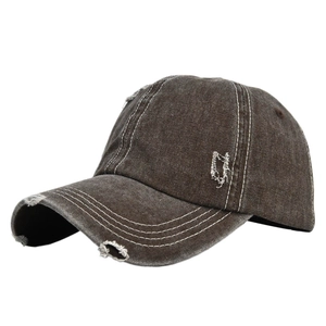 Detail of distressed brown denim baseball cap with white contrast stitching and torn holes