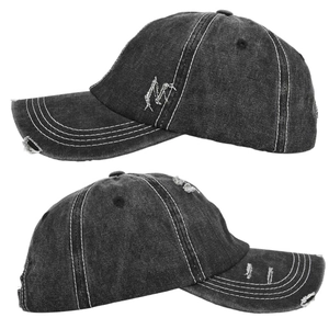 Detail of distressed charcoal denim baseball cap showing white stitching and torn edges
