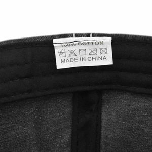 Detail of 100% cotton wash label and interior stitching of the grey baseball cap