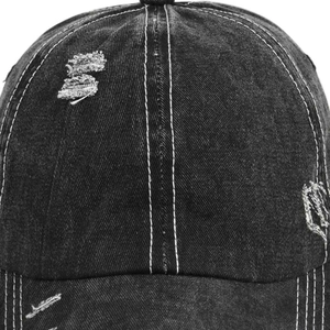 Close-up detail of vintage distressed denim baseball cap with white contrast stitching