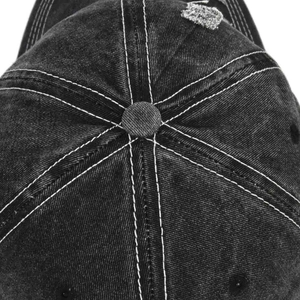 Detail of vintage washed denim baseball cap with contrast stitching and top button