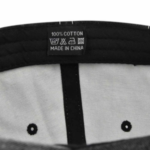Macro detail of the 100% cotton wash label and interior stitching of the baseball cap