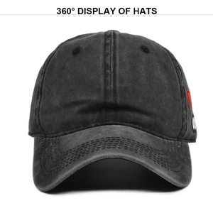 Detailed view of washed black cotton baseball cap with red heart embroidery on side