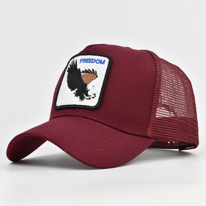 Detail view of burgundy baseball cap featuring eagle embroidery and breathable mesh back