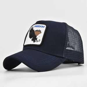 Detail of navy blue trucker hat featuring Freedom eagle patch and mesh ventilation