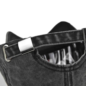Detail of grey washed denim baseball cap with metal buckle and patterned lining