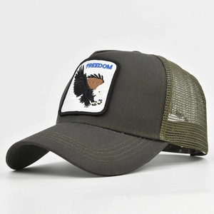 Detail of FREEDOM eagle patch embroidery on green mesh trucker hat with cotton twill