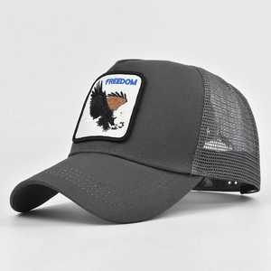 Detail view of the gray trucker hat featuring FREEDOM text and embroidered eagle patch