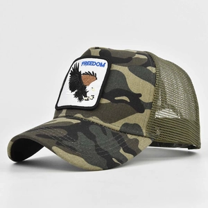 Detail of freedom eagle embroidery on camouflage mesh back trucker hat with curved brim