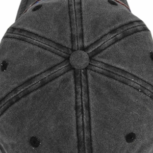 Detail view of the washed cotton fabric texture and stitching on the baseball cap crown