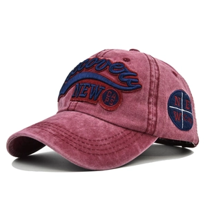 Close-up of 3D embroidery and washed vintage texture on burgundy baseball cap