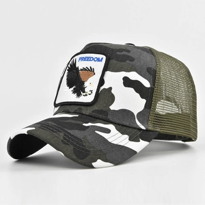 Detail of camouflage trucker hat with eagle embroidery patch and breathable green mesh back