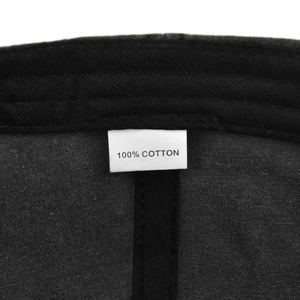 Detail showing the 100 percent cotton material label and twill fabric of the baseball cap