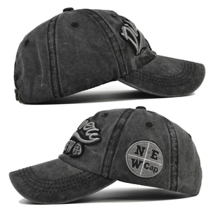 Detail view of 3D embroidery and side patch on washed charcoal grey baseball cap