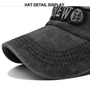 Detailed close-up of 3D embroidery and vintage washed fabric on dark grey baseball cap