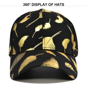 Detailed front view of black baseball cap with metallic golden feather print and curved brim