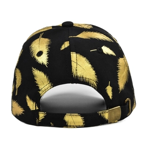 Detail of adjustable metal buckle and gold leaf print on black cotton baseball cap