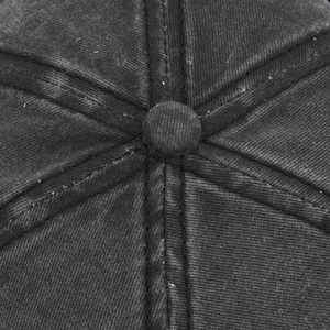 Close-up of washed denim baseball cap crown showing stitching and top button detail