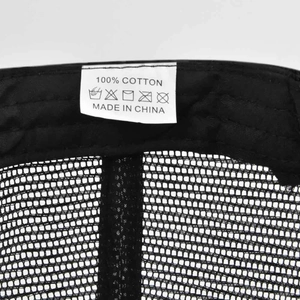 Detailed macro view of 100% cotton material and stitching inside the mesh baseball cap