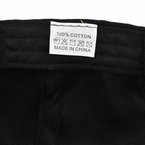 Close-up of baseball cap wash label showing 100% cotton fabric and care instructions
