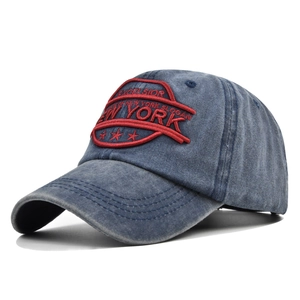 Close-up of red 3D Excelsior New York embroidery on a vintage navy denim baseball cap