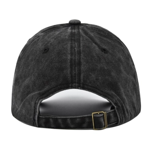 Close-up of adjustable bronze metal buckle and washed denim strap on black baseball cap