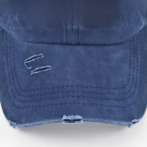 Close-up of the distressed brim and 3D embroidered stripes on this navy washed cotton cap