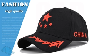 Close-up of red star and wheat ear embroidery on a black cotton baseball cap