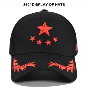 Detail of red five-star and wheat ear embroidery on a black cotton baseball cap